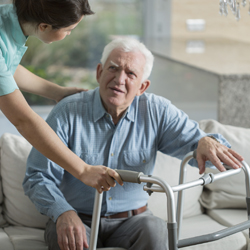 Assisting elderly man with a frame
