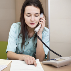 Medical worker in an office making a phone call