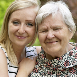  Young woman and older woman smiling outside 