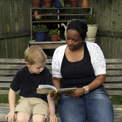 Woman reading to a young boy