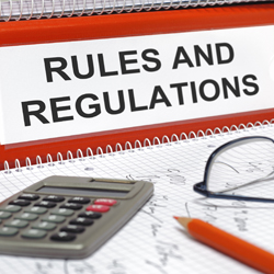 Pencil, calculator and binder marked ‘Rules and regulations’
