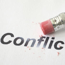 Pencil erasing the word ‘conflict’