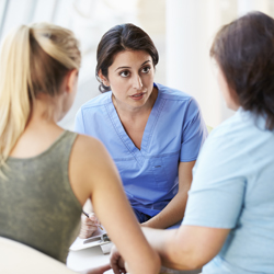 Nurse meeting with two clients