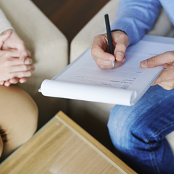 A person filling in a form