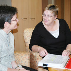 Two community services workers in discussion